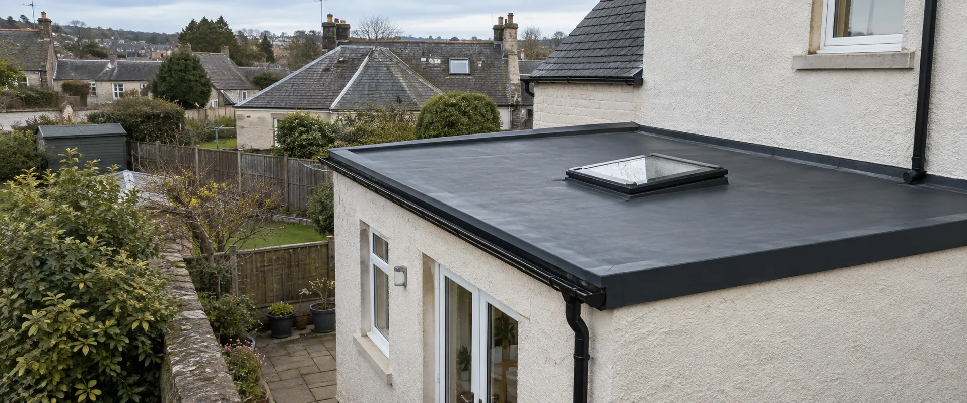 Illustrative EPDM flat roof with perimeter trim and a rooflight on a domestic extension.