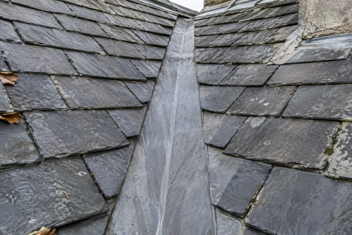 Illustrative clear lead valley channel bordered by cut natural slates.